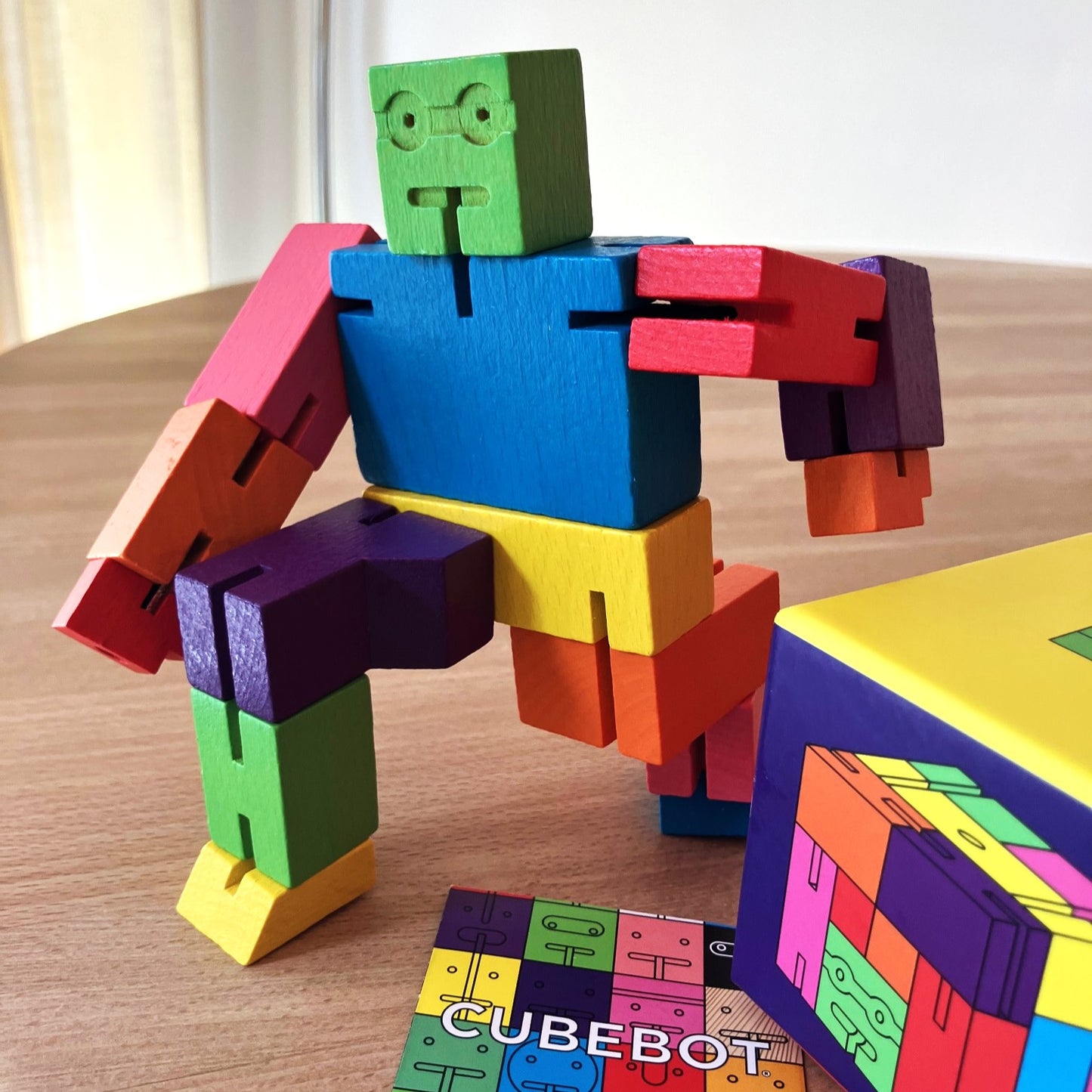 Poseable wooden Cubebot— clever puzzle toy and funny desk decoration.