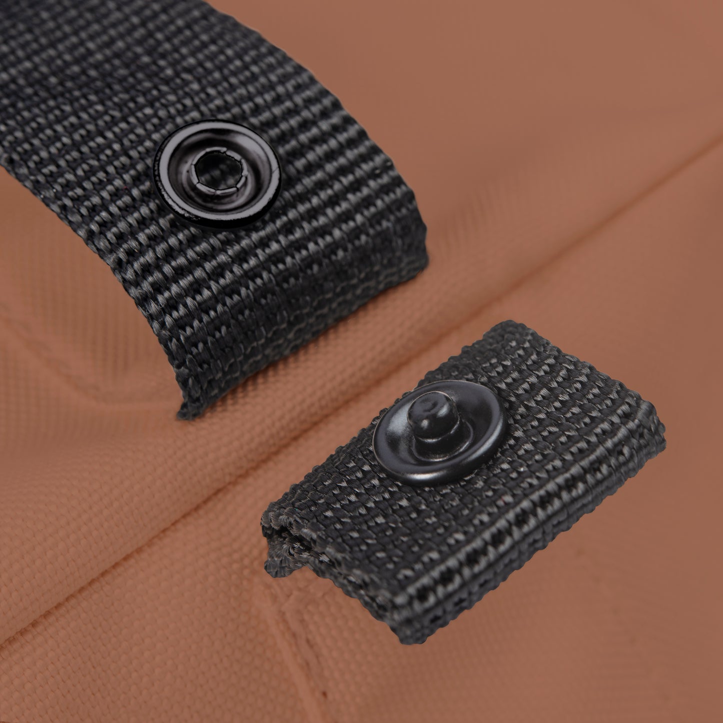 Multifunctional Notabag shown folded as tote, with adjustable strap and press studs for easy resizing